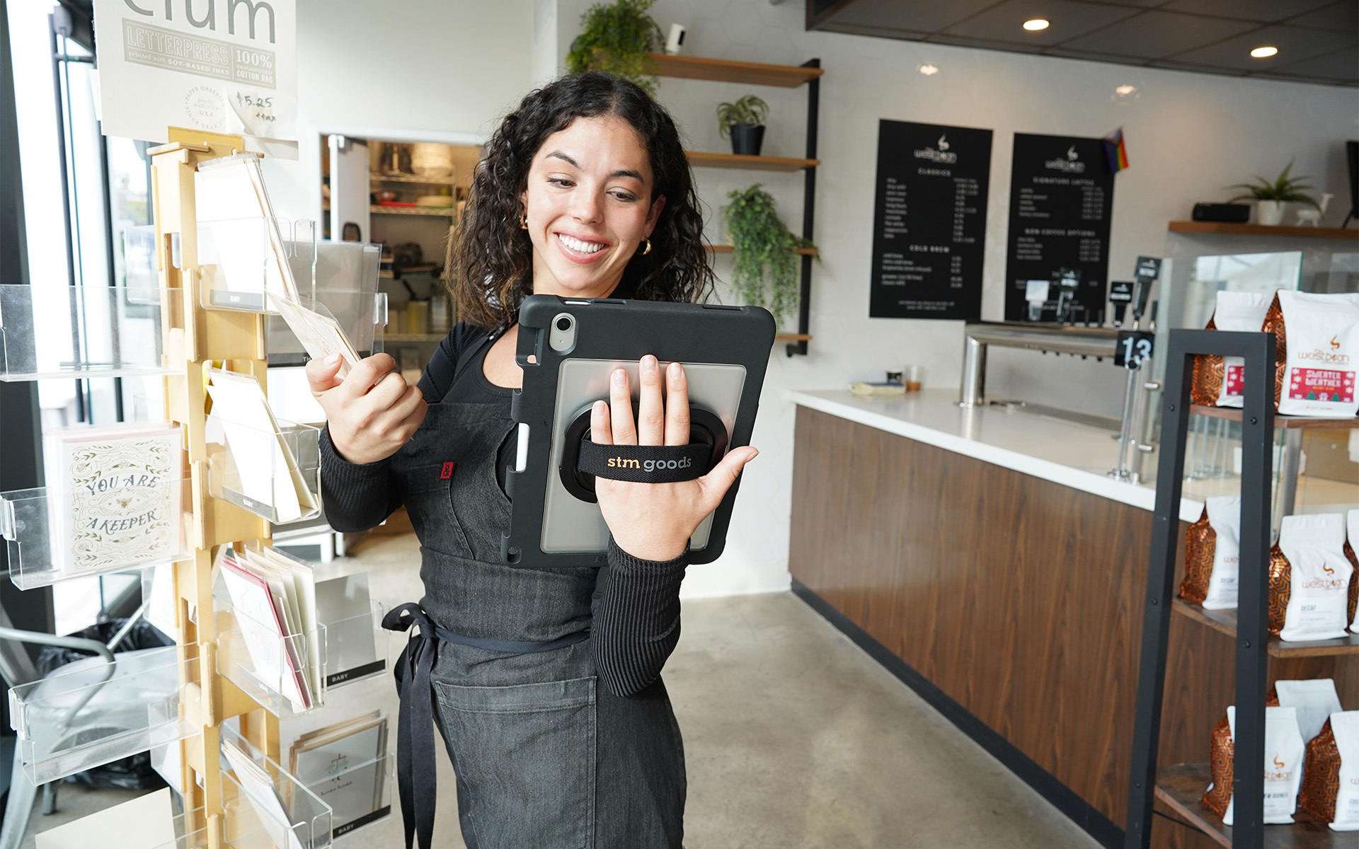 Women in shop holding greeting card in one hand, Dux Swivel in the other