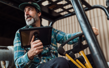 Bearded man in forklift truck with Dux Swivel in his right hand